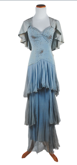 A powder blue tiered dress with caped sleeves and embellished with sequences over the bodice.
